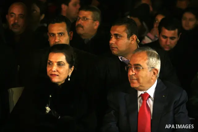 Palestinian prime minister Salam Fayyad watches the lighting of a Christmas tree at Manger Square, outside the Church of the Nativity in West Bank town of Bethlehem,Thursday, Dec. 15, 2011. Christian worshippers began th...