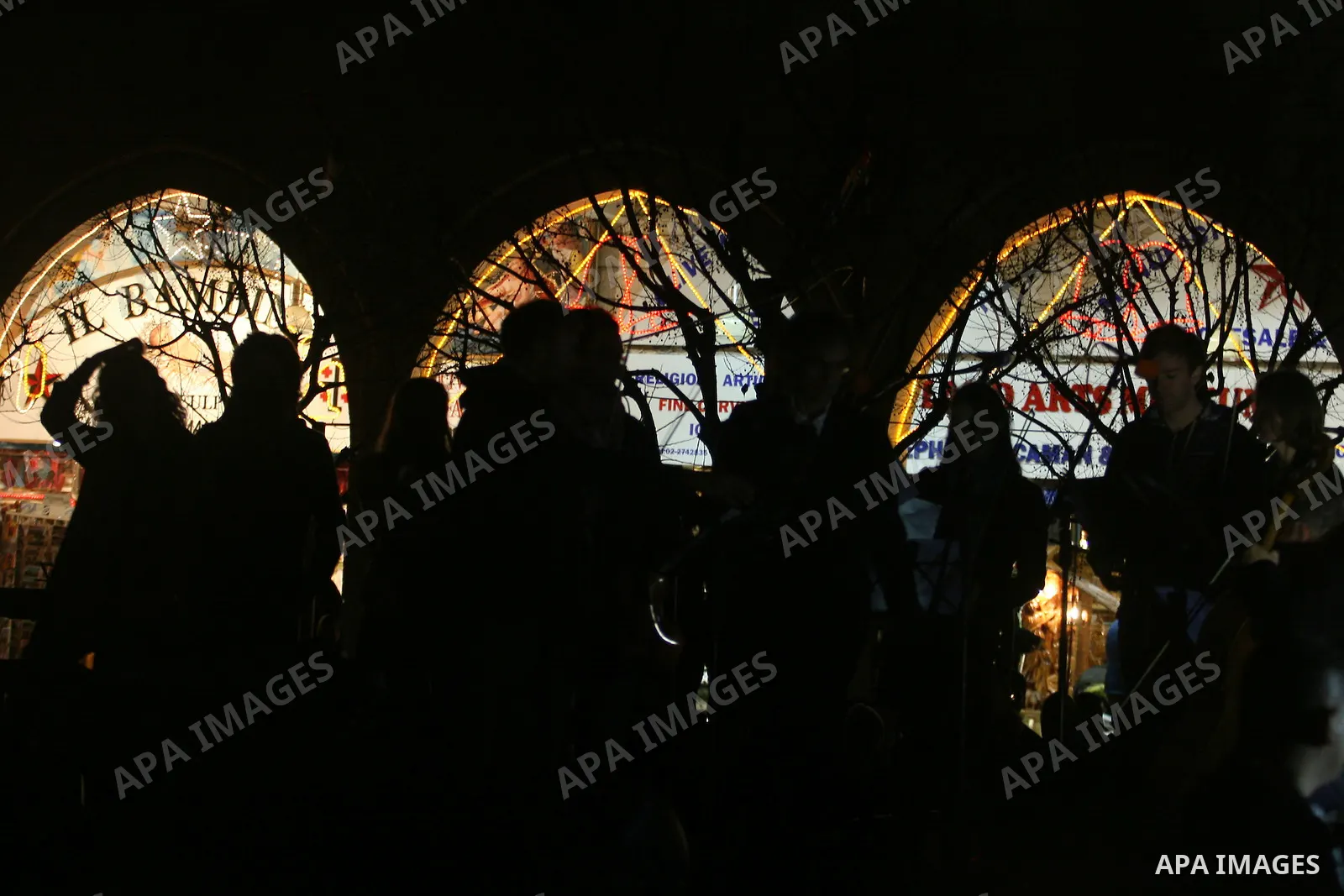 Palestinians watch the lighting of a Christmas tree at Manger Square, outside the Church of the Nativity in West Bank town of Bethlehem,Thursday, Dec. 15, 2011. Christian worshippers began their spiritual preparations ah...