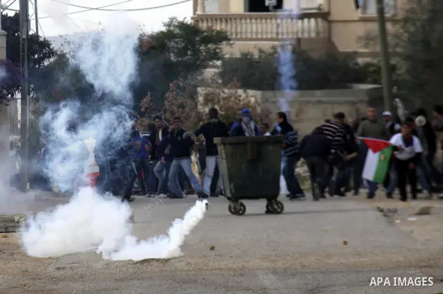 Israeli border police officers clash with Palestinian demonstrators during a protest in the village of Kufr Qaddum near the Israeli settlement of Kdumim, in the northern West Bank, Friday, Dec. 16, 2011. Photo by Wagdi E...
