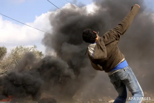 Israeli border police officers clash with Palestinian demonstrators during a protest in the village of Kufr Qaddum near the Israeli settlement of Kdumim, in the northern West Bank, Friday, Dec. 16, 2011. Photo by Wagdi E...