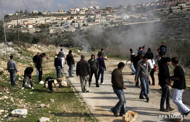 Israeli border police officers clash with Palestinian demonstrators during a protest in the village of Kufr Qaddum near the Israeli settlement of Kdumim, in the northern West Bank, Friday, Dec. 16, 2011. Photo by Wagdi E...
