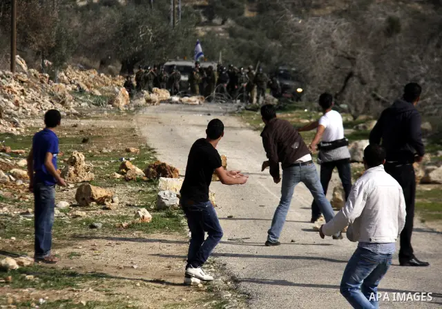 Israeli border police officers clash with Palestinian demonstrators during a protest in the village of Kufr Qaddum near the Israeli settlement of Kdumim, in the northern West Bank, Friday, Dec. 16, 2011. Photo by Wagdi E...