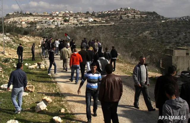 Israeli border police officers clash with Palestinian demonstrators during a protest in the village of Kufr Qaddum near the Israeli settlement of Kdumim, in the northern West Bank, Friday, Dec. 16, 2011. Photo by Wagdi E...