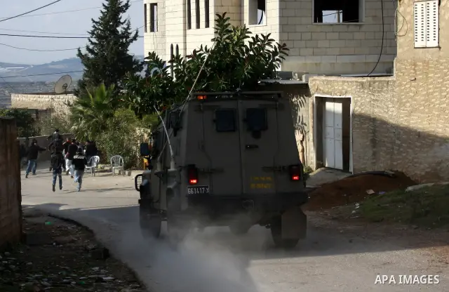Israeli border police officers clash with Palestinian demonstrators during a protest in the village of Kufr Qaddum near the Israeli settlement of Kdumim, in the northern West Bank, Friday, Dec. 16, 2011. Photo by Wagdi E...