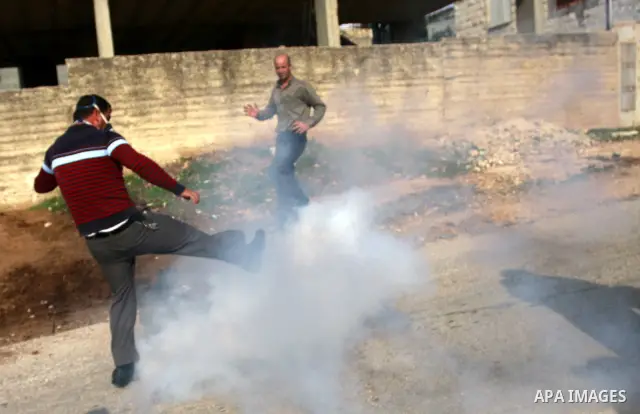 Israeli border police officers clash with Palestinian demonstrators during a protest in the village of Kufr Qaddum near the Israeli settlement of Kdumim, in the northern West Bank, Friday, Dec. 16, 2011. Photo by Wagdi E...