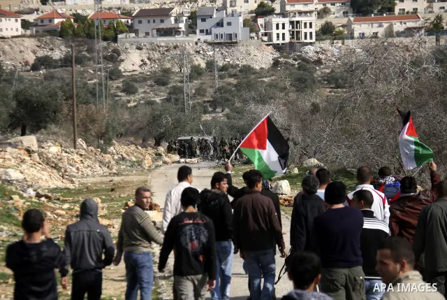 Israeli border police officers clash with Palestinian demonstrators during a protest in the village of Kufr Qaddum near the Israeli settlement of Kdumim, in the northern West Bank, Friday, Dec. 16, 2011. Photo by Wagdi E...