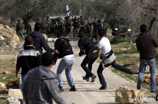 Israeli border police officers clash with Palestinian demonstrators during a protest in the village of Kufr Qaddum near the Israeli settlement of Kdumim, in the northern West Bank, Friday, Dec. 16, 2011. Photo by Wagdi E...