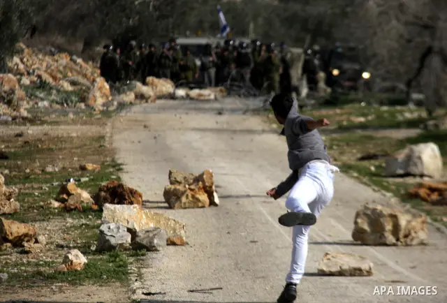 Israeli border police officers clash with Palestinian demonstrators during a protest in the village of Kufr Qaddum near the Israeli settlement of Kdumim, in the northern West Bank, Friday, Dec. 16, 2011. Photo by Wagdi E...