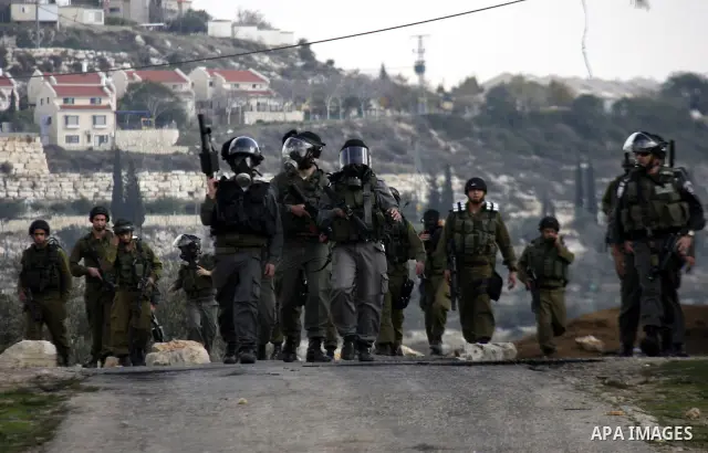 Israeli border police officers clash with Palestinian demonstrators during a protest in the village of Kufr Qaddum near the Israeli settlement of Kdumim, in the northern West Bank, Friday, Dec. 16, 2011. Photo by Wagdi E...