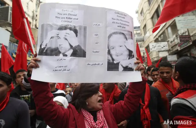 Palestinians wave red flags during a rally to mark the 44th anniversary of the leftist Popular Front for the Liberation of Palestine (PFLP) in the West Bank of Nablus. Saturday , Dec. 17, 2011. Photo by Wagdi Eshtayah.