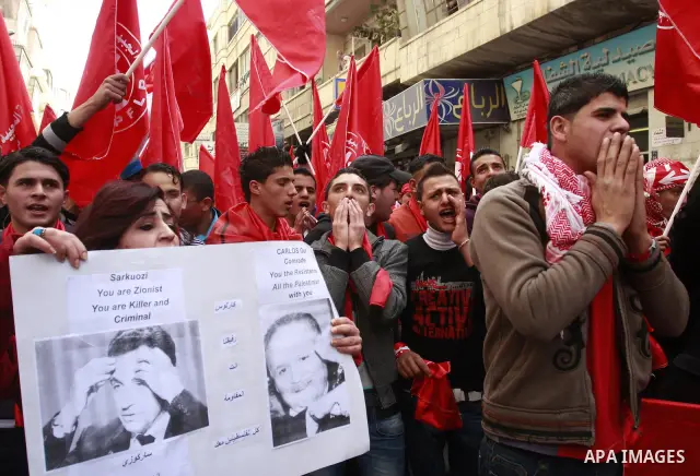Palestinians wave red flags during a rally to mark the 44th anniversary of the leftist Popular Front for the Liberation of Palestine (PFLP) in the West Bank of Nablus. Saturday , Dec. 17, 2011. Photo by Wagdi Eshtayah.