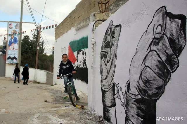Palestinian relatives of prisoner Younis Jahjouh decorate the street ahead of his release from Israeli prisons in the Qalandia refugee camp near the West Bank city of Ramallah, Saturday, Dec 17, 2011. Israel is set to re...
