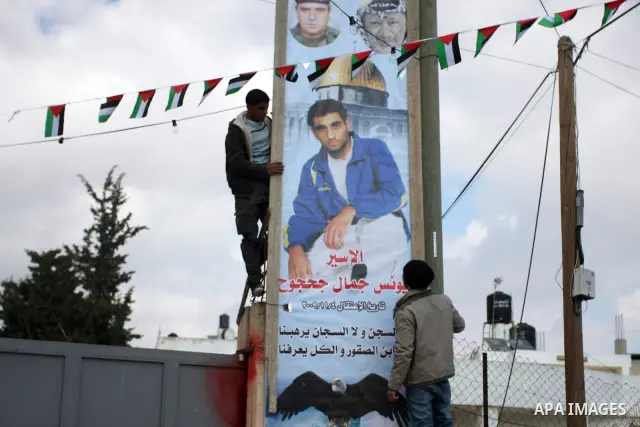 Palestinian relatives of prisoner Younis Jahjouh decorate the street ahead of his release from Israeli prisons in the Qalandia refugee camp near the West Bank city of Ramallah, Saturday, Dec 17, 2011. Israel is set to re...