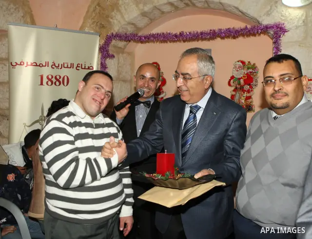 Palestinian Prime Minister Salam Fayyad attends the Christmas tree lighting celebration in the West Bank town of Beit Shour, near Bethlehem, on Dec. 17, 2011. Photo by Mustafa Abu Dayeh