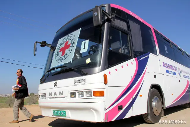 Red Cross vehicles arrive in Rafah border crossing, in southern Gaza Strip, on Dec. 18, 2011. About 40 live in Gaza Strip from the total 550 Palestinian prisoners will be freed on Sunday from Israeli jails, in the second...