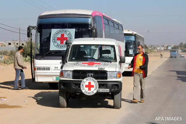 Red Cross vehicles arrive in Rafah border crossing, in southern Gaza Strip, on Dec. 18, 2011. About 40 live in Gaza Strip from the total 550 Palestinian prisoners will be freed on Sunday from Israeli jails, in the second...