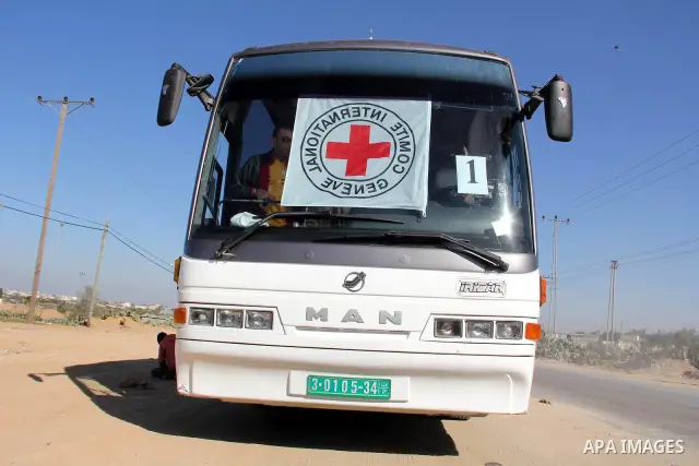 Red Cross vehicles arrive in Rafah border crossing, in southern Gaza Strip, on Dec. 18, 2011. About 40 live in Gaza Strip from the total 550 Palestinian prisoners will be freed on Sunday from Israeli jails, in the second...