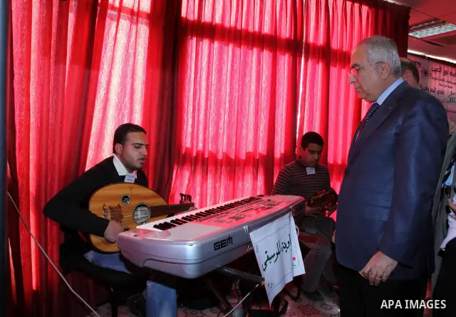 Palestinian Prime Minister Salam Fayyad visits the exhibition organized by Noor Al Ain "the light of eye" Association for the blind and visually impaired in the West Bank city of Ramallah on Dec. 18, 2011. Photo by Musta...