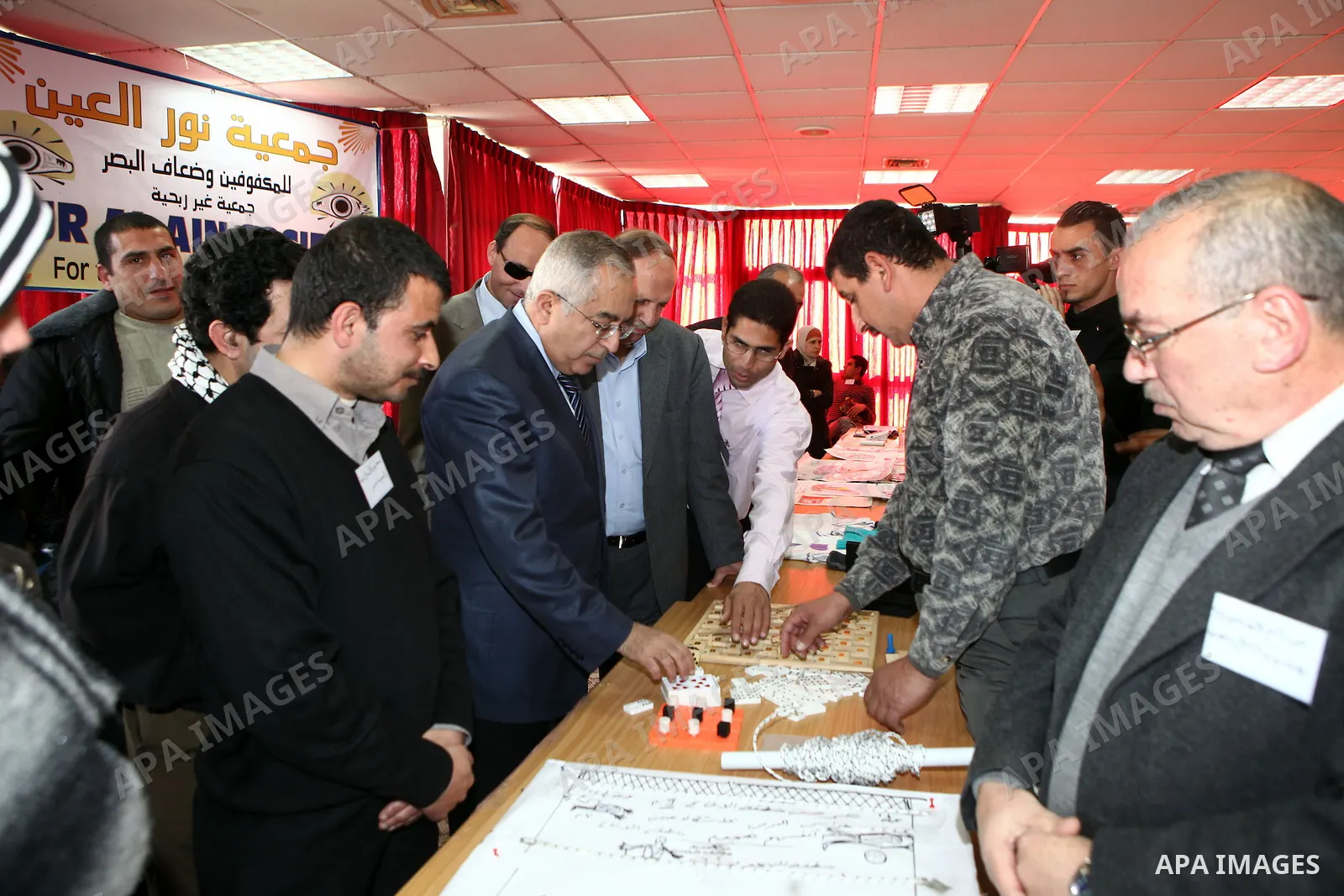 Palestinian Prime Minister Salam Fayyad visits the exhibition organized by Noor Al Ain "the light of eye" Association for the blind and visually impaired in the West Bank city of Ramallah on Dec. 18, 2011. Photo by Musta...