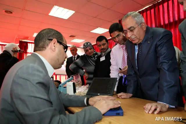Palestinian Prime Minister Salam Fayyad visits the exhibition organized by Noor Al Ain "the light of eye" Association for the blind and visually impaired in the West Bank city of Ramallah on Dec. 18, 2011. Photo by Musta...