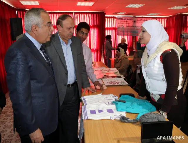 Palestinian Prime Minister Salam Fayyad visits the exhibition organized by Noor Al Ain "the light of eye" Association for the blind and visually impaired in the West Bank city of Ramallah on Dec. 18, 2011. Photo by Musta...