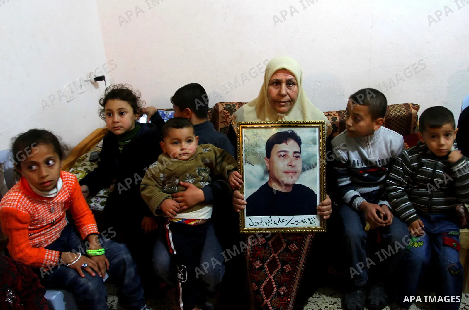 The mother of Palestinian prisoner Ali Abu Fool holds his picture before his release from an Israeli jail, in Gaza City December 18, 2011. Israel plans to release 550 Palestinian prisoners on Sunday in the second stage o...