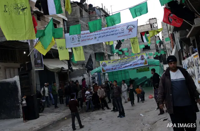 Relatives of Palestinian prisoner Ali Abu Fool gather before his release from an Israeli jail, in Gaza City December 18, 2011. Israel plans to release 550 Palestinian prisoners on Sunday in the second stage of a deal wit...