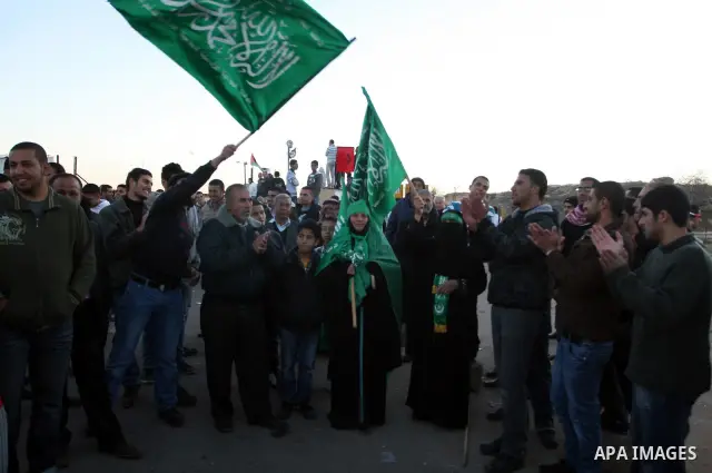 Relatives of Palestinian prisoners wait outside Ofer prison, near the West Bank city of Ramallah December 18, 2011. Clashes erupted while Palestinians gathered to wait for the release of Palestinian prisoners. Israel pla...