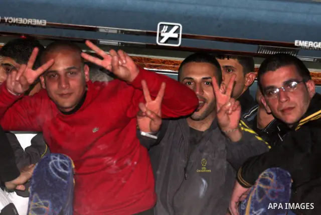 Newly released Palestinian prisoners wait to disembark from a bus upon their arrival to the West Bank city of Ramallah December 18, 2011. Israel released 550 Palestinian prisoners on Sunday in the second stage of a deal...