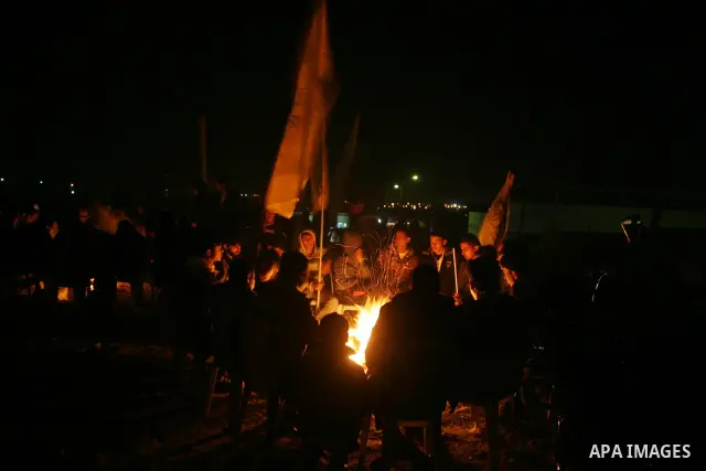 People celebrate as they wait for the release of Palestinian prisoners from Israeli jails at Rafah crossing in the southern Gaza Strip December 18, 2011. Israel plans to release 550 Palestinian prisoners on Sunday in the...