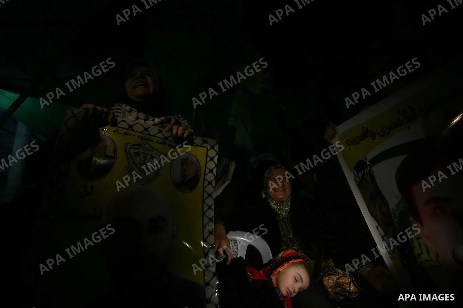 People celebrate as they wait for the release of Palestinian prisoners from Israeli jails at Rafah crossing in the southern Gaza Strip December 18, 2011. Israel plans to release 550 Palestinian prisoners on Sunday in the...