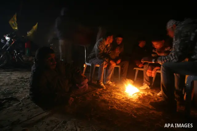 People celebrate as they wait for the release of Palestinian prisoners from Israeli jails at Rafah crossing in the southern Gaza Strip December 18, 2011. Israel plans to release 550 Palestinian prisoners on Sunday in the...