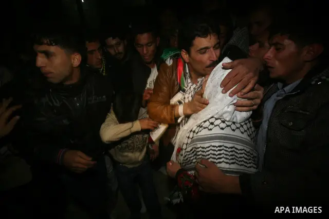 A Palestinian prisoner hugs his relatives as he arrives in Rafah, crossing in southern Gaza strip, after being released on December 18, 2011. Israel today freed 550 Palestinian prisoners, completing the second phase of a...