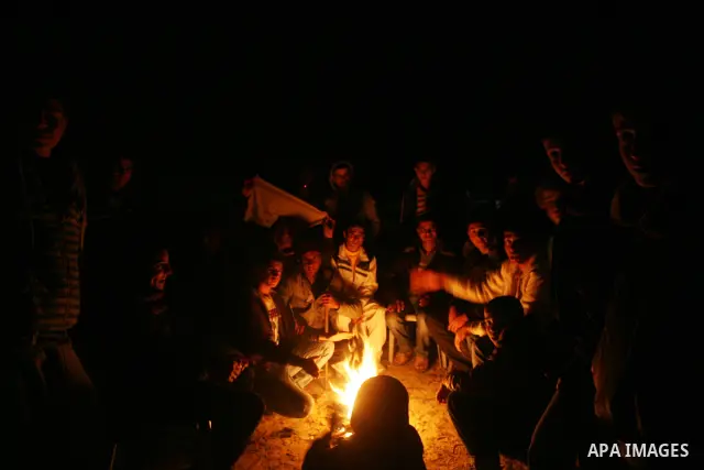 People celebrate as they wait for the release of Palestinian prisoners from Israeli jails at Rafah crossing in the southern Gaza Strip December 18, 2011. Israel plans to release 550 Palestinian prisoners on Sunday in the...