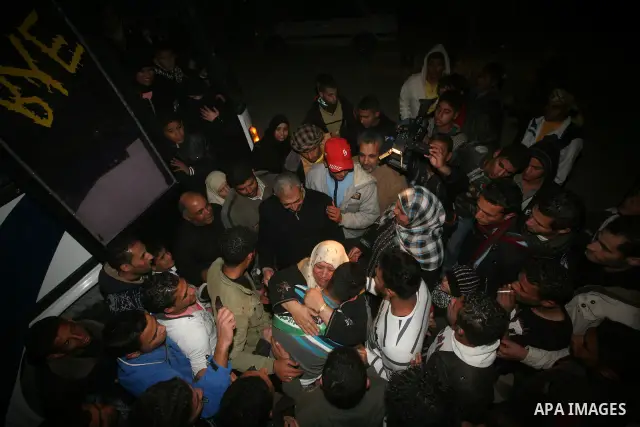 A Palestinian prisoner hugs his relatives as he arrives in Rafah, crossing in southern Gaza strip, after being released on December 18, 2011. Israel today freed 550 Palestinian prisoners, completing the second phase of a...