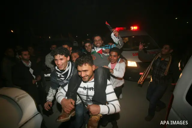 A Palestinian prisoner hugs his relatives as he arrives in Rafah, crossing in southern Gaza strip, after being released on December 18, 2011. Israel today freed 550 Palestinian prisoners, completing the second phase of a...