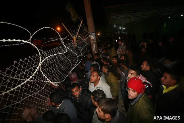 People celebrate as they wait for the release of Palestinian prisoners from Israeli jails at Rafah crossing in the southern Gaza Strip December 18, 2011. Israel plans to release 550 Palestinian prisoners on Sunday in the...