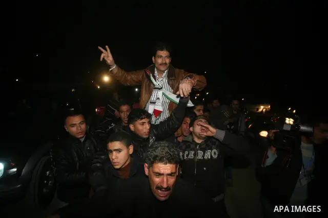 A Palestinian prisoner hugs his relatives as he arrives in Rafah, crossing in southern Gaza strip, after being released on December 18, 2011. Israel today freed 550 Palestinian prisoners, completing the second phase of a...