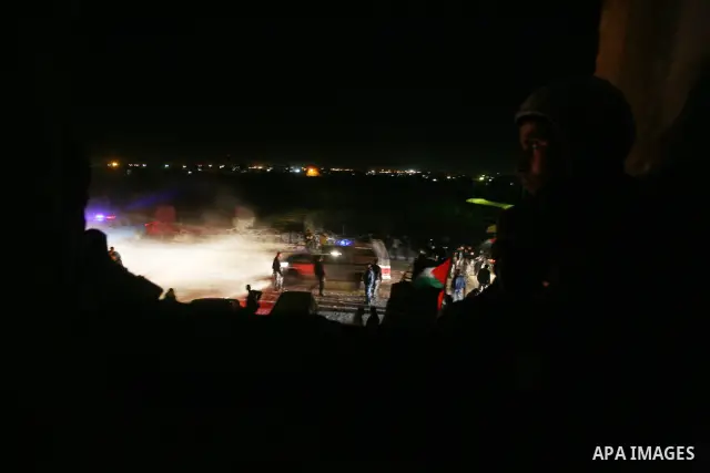 People celebrate as they wait for the release of Palestinian prisoners from Israeli jails at Rafah crossing in the southern Gaza Strip December 18, 2011. Israel plans to release 550 Palestinian prisoners on Sunday in the...