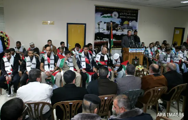 Freed Palestinian prisoners wait to be honored upon arrival at Rafah crossing in the southern Gaza Strip December 18, 2011. Israel plans to release 550 Palestinian prisoners on Sunday in the second stage of a deal with H...