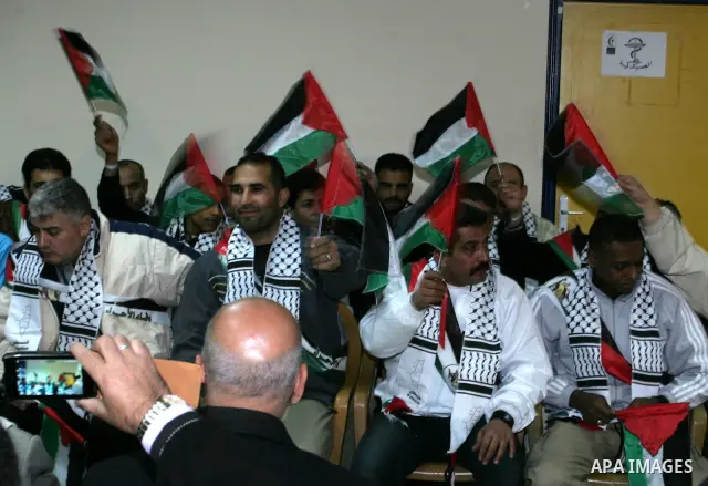 Freed Palestinian prisoners wait to be honored upon arrival at Rafah crossing in the southern Gaza Strip December 18, 2011. Israel plans to release 550 Palestinian prisoners on Sunday in the second stage of a deal with H...