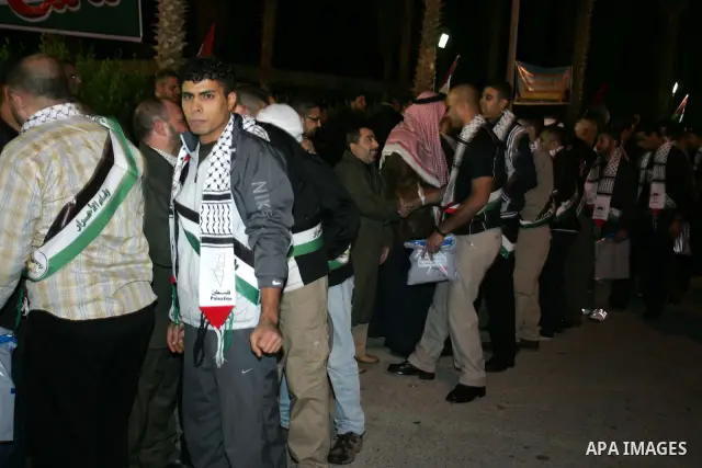 Freed Palestinian prisoners stand in line as they wait to be honored upon arrival at Rafah crossing in the southern Gaza Strip December 18, 2011. Israel plans to release 550 Palestinian prisoners on Sunday in the second...