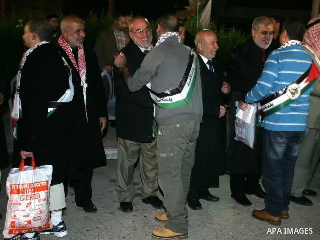 Freed Palestinian prisoners stand in line as they wait to be honored upon arrival at Rafah crossing in the southern Gaza Strip December 18, 2011. Israel plans to release 550 Palestinian prisoners on Sunday in the second...