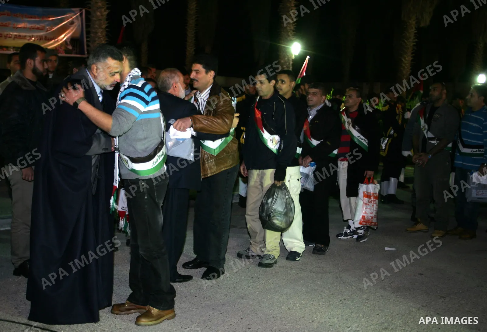 Freed Palestinian prisoners stand in line as they wait to be honored upon arrival at Rafah crossing in the southern Gaza Strip December 18, 2011. Israel plans to release 550 Palestinian prisoners on Sunday in the second...