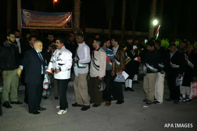Freed Palestinian prisoners stand in line as they wait to be honored upon arrival at Rafah crossing in the southern Gaza Strip December 18, 2011. Israel plans to release 550 Palestinian prisoners on Sunday in the second...