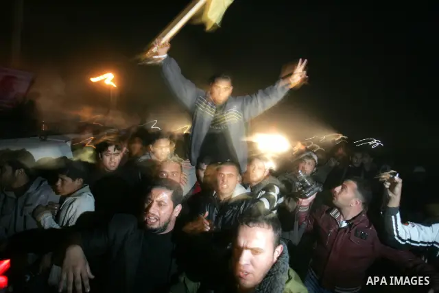 A freed Palestinian prisoners is greeted upon arrival at Rafah crossing in the southern Gaza Strip December 18, 2011. Israel plans to release 550 Palestinian prisoners on Sunday in the second stage of a deal with Hamas t...