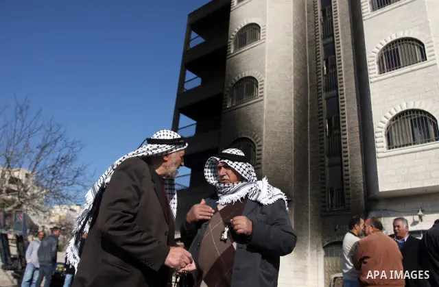 Palestinian men inspects burnt cars after unidentified assailants torched them in the West Bank village of Beitin, north of Ramallah, on December 19, 2011 in a possible revenge attack by extremist Jews, police said. Phot...