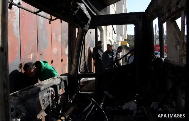 Palestinian men inspects burnt cars after unidentified assailants torched them in the West Bank village of Beitin, north of Ramallah, on December 19, 2011 in a possible revenge attack by extremist Jews, police said. Phot...