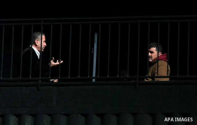Palestinian men inspects burnt cars and a damaged building after an attack by unidentified assailants in the West Bank village of Beitin, north of Ramallah, on December 19, 2011 in a possible revenge attack by extremist...