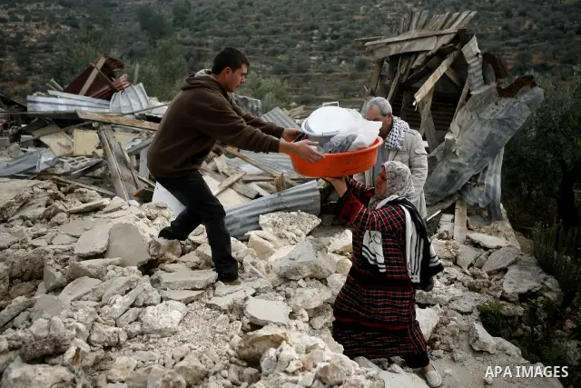 Palestinians inspect a house which was demolished by Israeli army in the occupied West Bank city of Nablus on December 21, 2011. Photo by Wagdi Eshtayah.